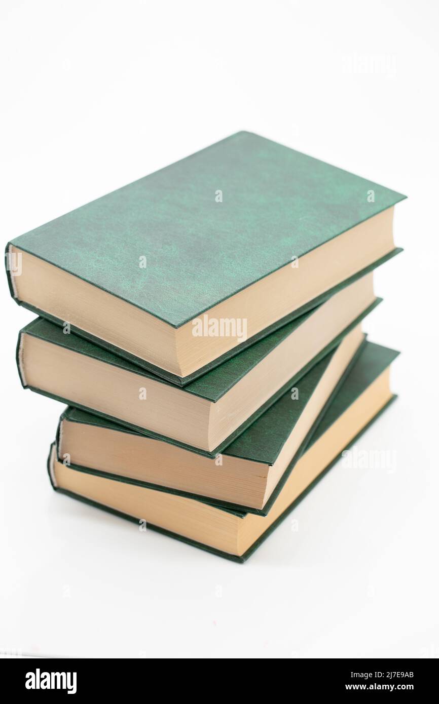 Reading of books. Books stack with green covers on a white background. Knowledge concept.Reading and education. Literature and reading  Stock Photo