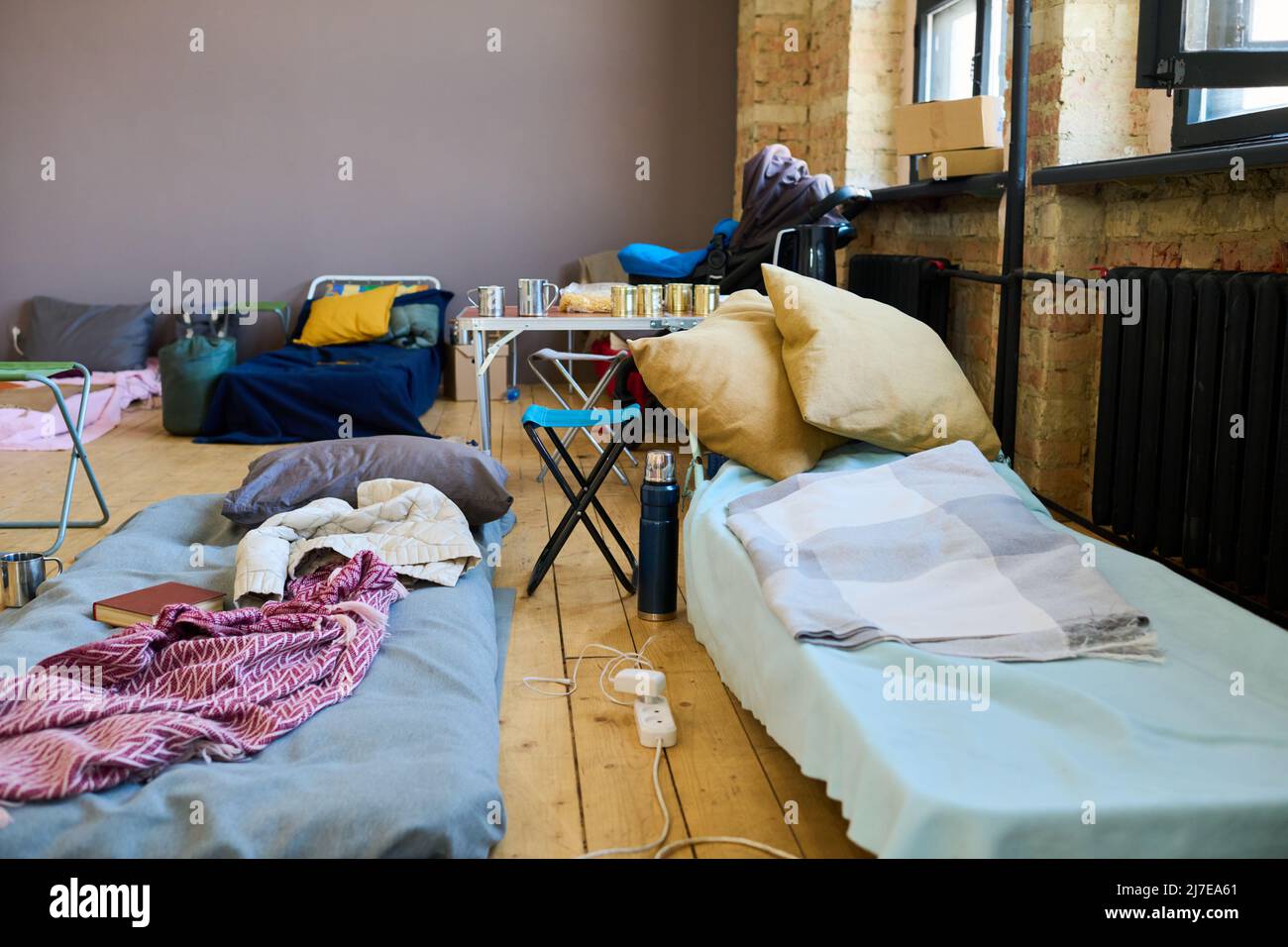 Two sleeping places of refugees with mattresses done with blankets or