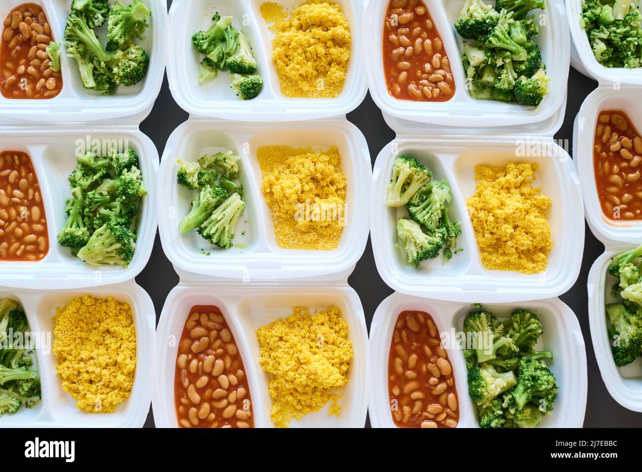 Layout of assortment of fresh cooked food in white plastic containers