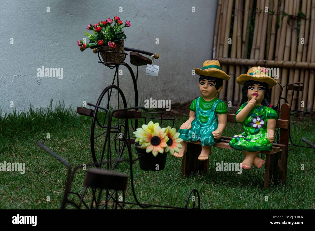 Garden ornaments for sale on an outdoor grass field of Rosa de Saron store. Local business specialized in metal handmade crafts. Stock Photo