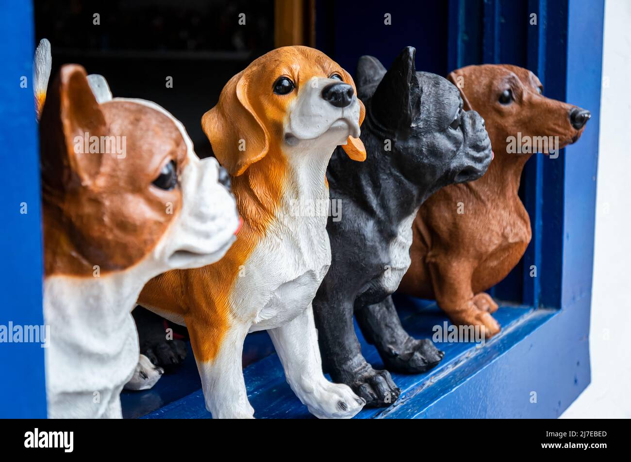 Some dog breeds for garden ornaments displayed at the window of Mar Belle handmade craft store at Inconfidentes street, nearby historical center. Stock Photo
