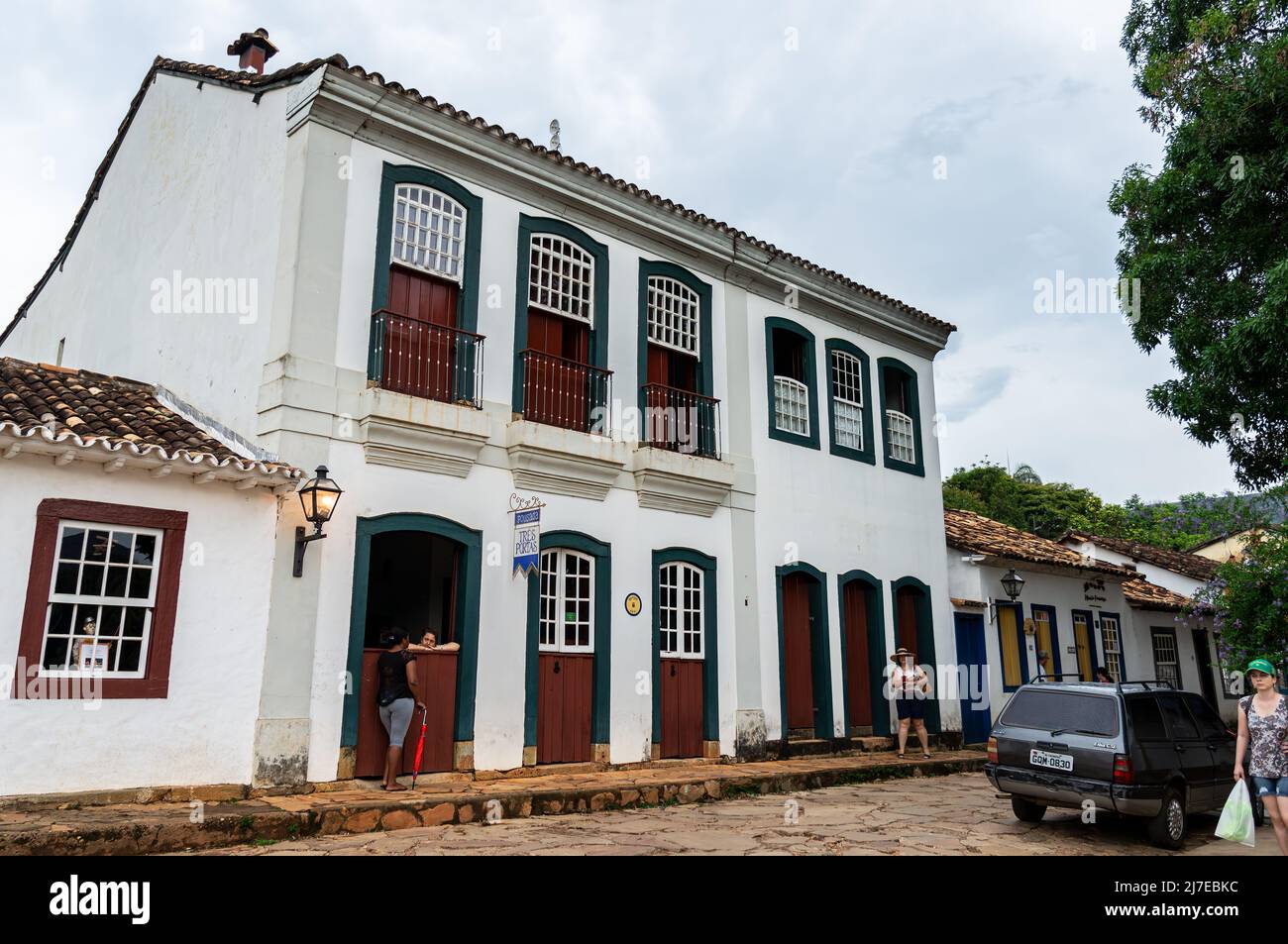 Facade of Tres Portas inn, a small hotel located at east end of Direita street in Tiradentes historical center under clouded sky. Stock Photo