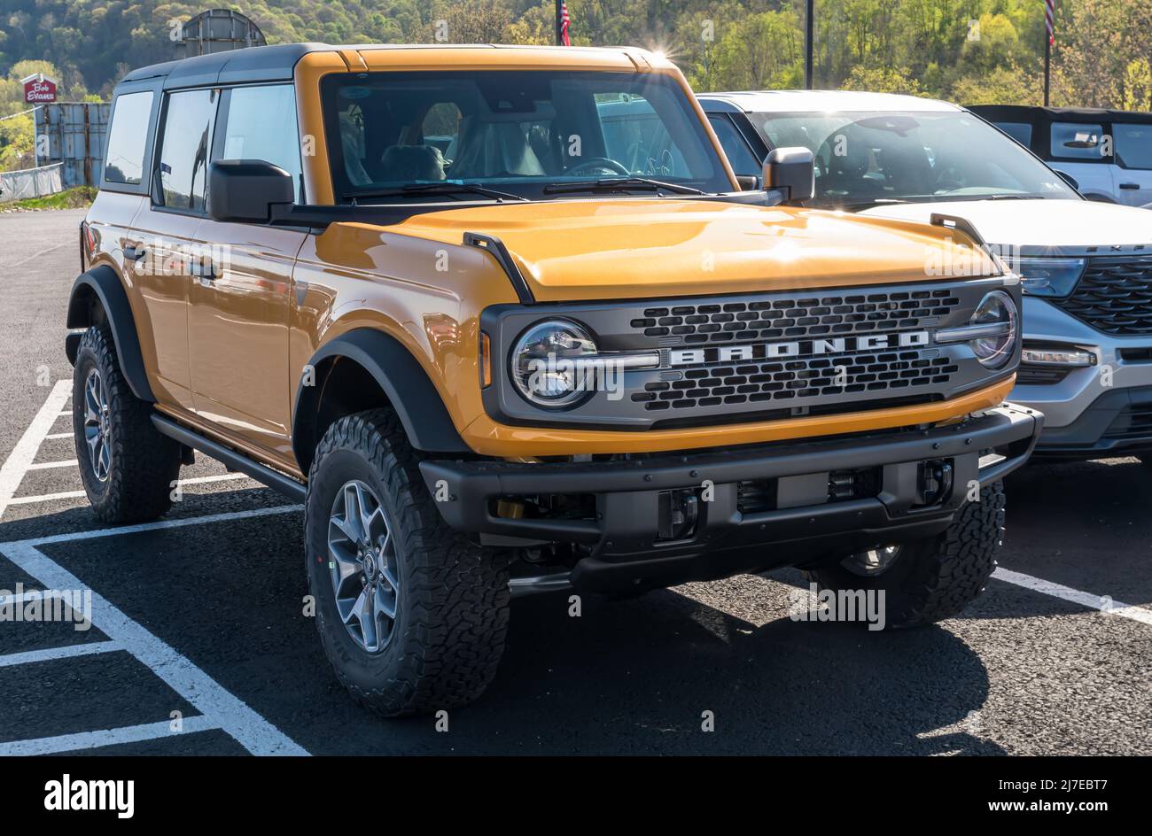 A new orange Ford Bronco SUV for sale at a dealership in Harmar
