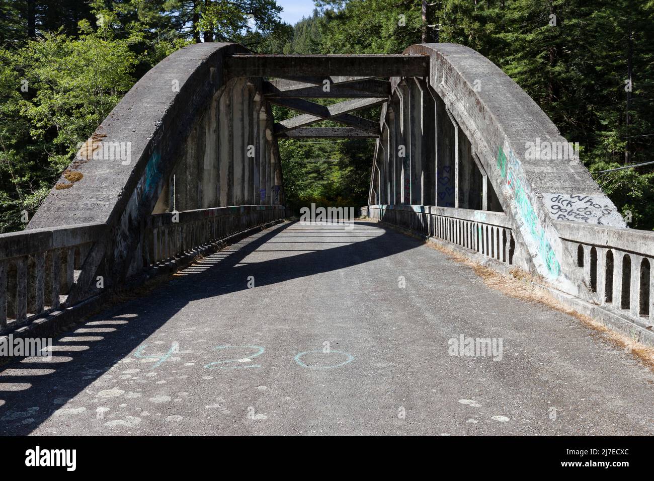 Abandoned tied arch bridge along State Highway 36 over the Van Duzen River in Northern California. Stock Photo