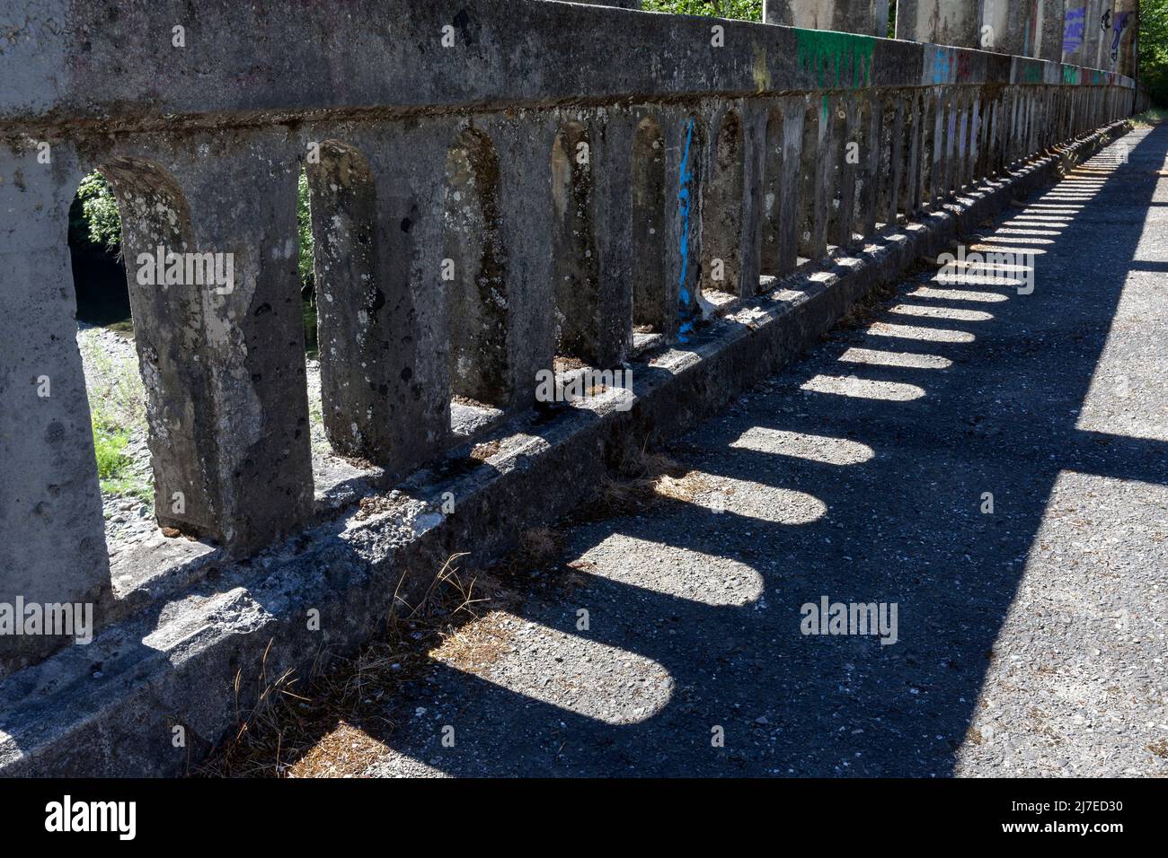 Side railing on an abandoned tied arch bridge along State Highway 36 over the Van Duzen River in Northern California. Stock Photo