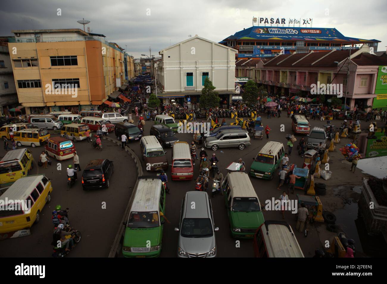 Traffic congestions on a road next to a commercial area in Palembang ...