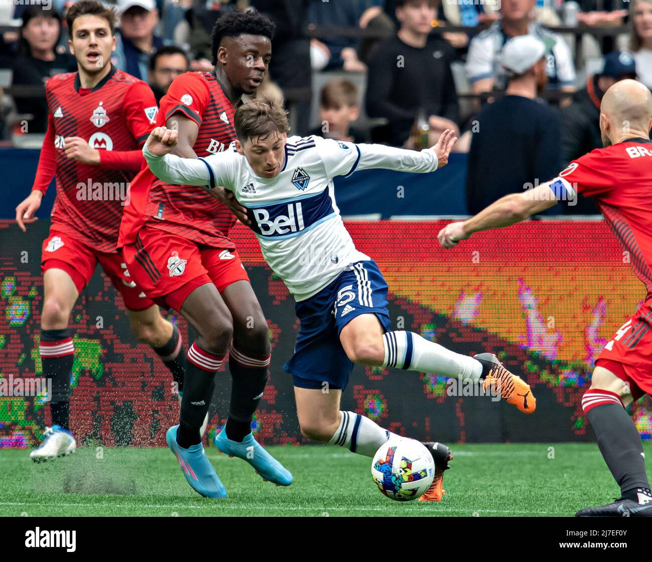 VANCOUVER, May 9, 2022 (Xinhua) -- Deandre Kerr (2nd L) of Toronto FC and Ryan Gauld of Vancouver Whitecaps compete during their MLS regular season football match in Vancouver, Canada, May 8, 2022. (Photo by Andrew Soong/Xinhua) Stock Photo