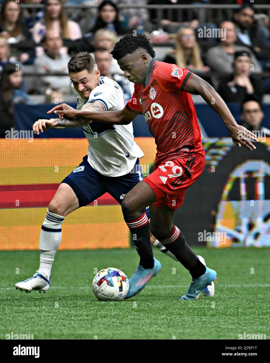 VANCOUVER, May 9, 2022 (Xinhua) -- Jake Nerwinski (L) of Vancouver Whitecaps and Deandre Kerr of Toronto FC compete during their MLS regular season football match in Vancouver, Canada, May 8, 2022. (Photo by Andrew Soong/Xinhua) Stock Photo