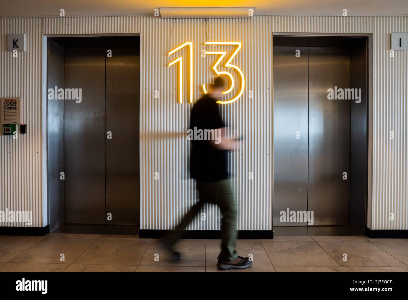 28 April 2022, Berlin: A man operates an elevator on the 13th floor. Photo: Christoph Soeder/dpa Stock Photo