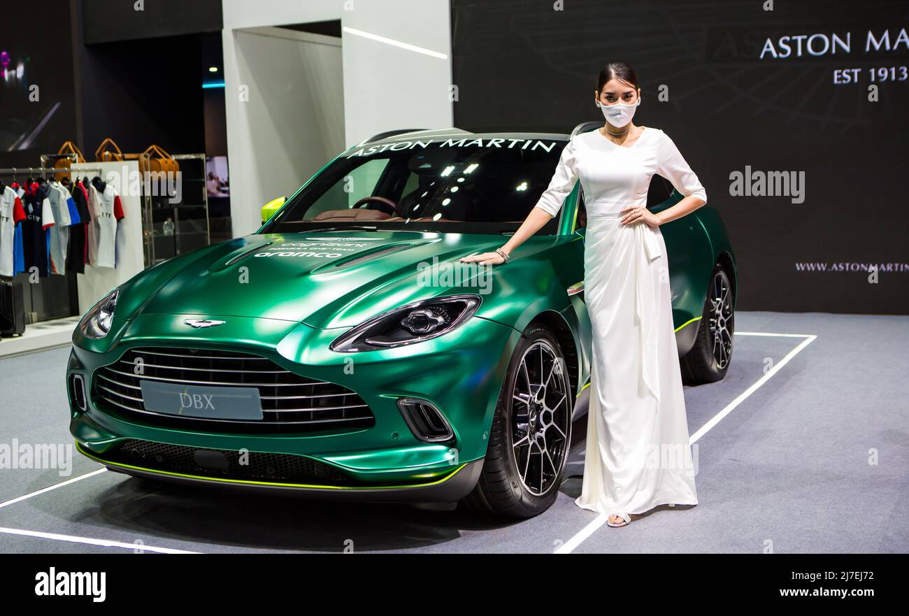 Nonthaburi, Thailand - March 24, 2022: Aston Martin DBX and female presenter displayed in Motor Show 2022 Stock Photo