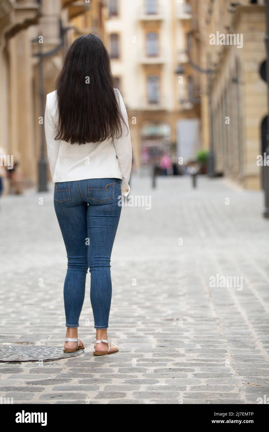Rear view of woman in the street Stock Photo - Alamy
