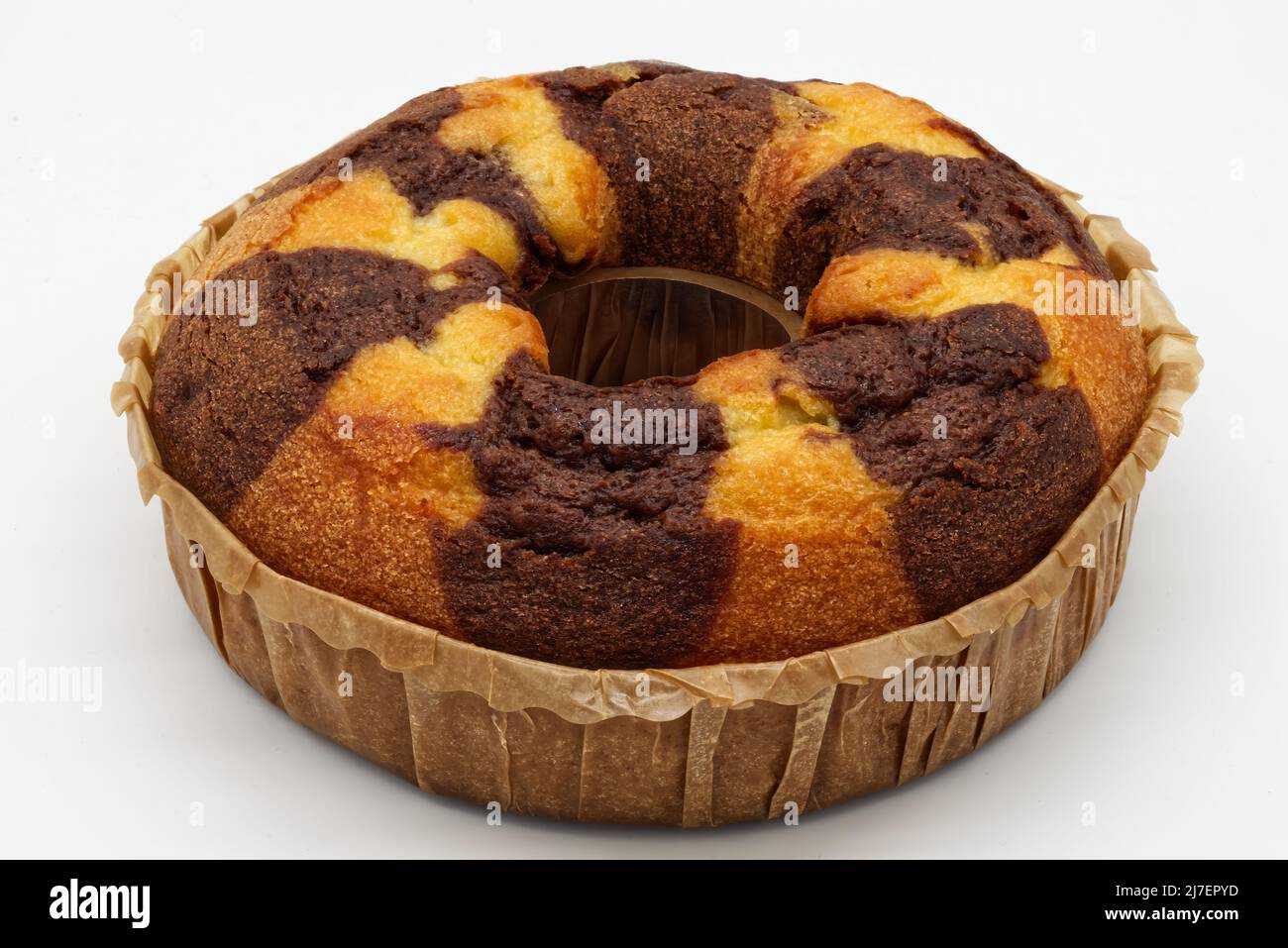 Bicolor cake on a baking sheet isolated on white background. Stock Photo