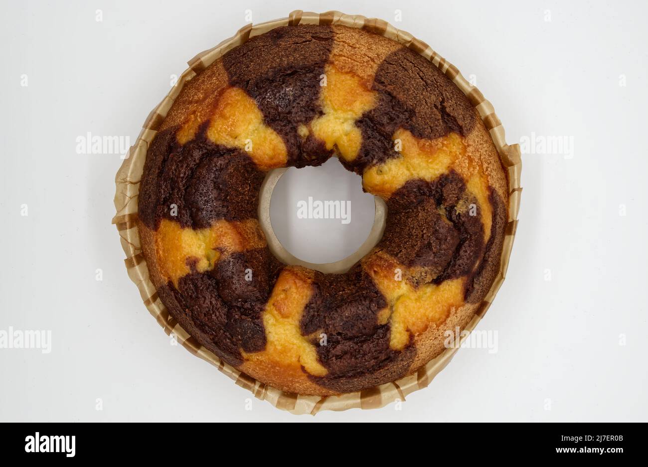 Bicolor cake on a baking sheet isolated on white background. Top view Stock Photo