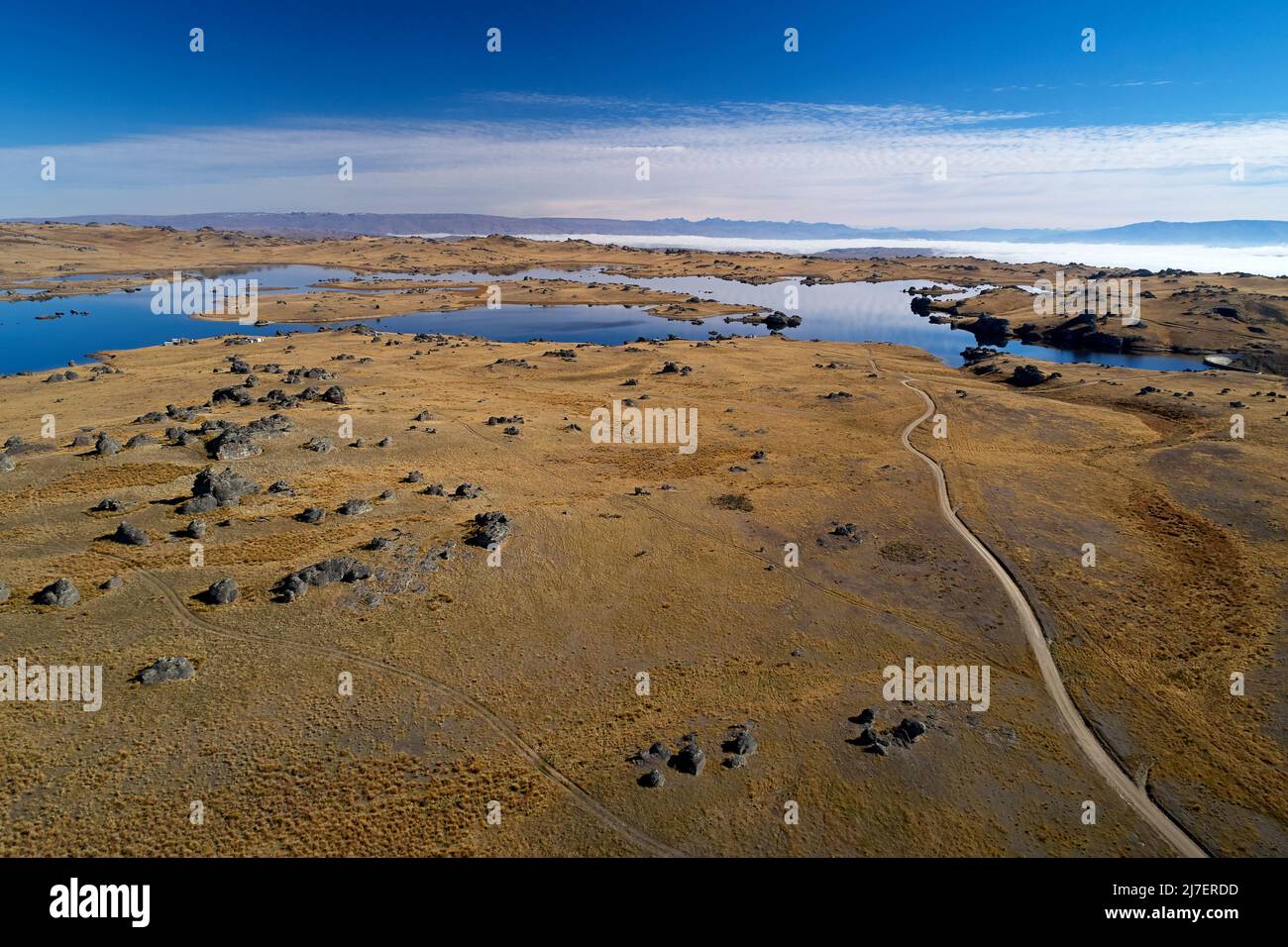 Rocky landscape and Poolburn Dam, Central Otago, South Island, New Zealand - drone aerial Stock Photo