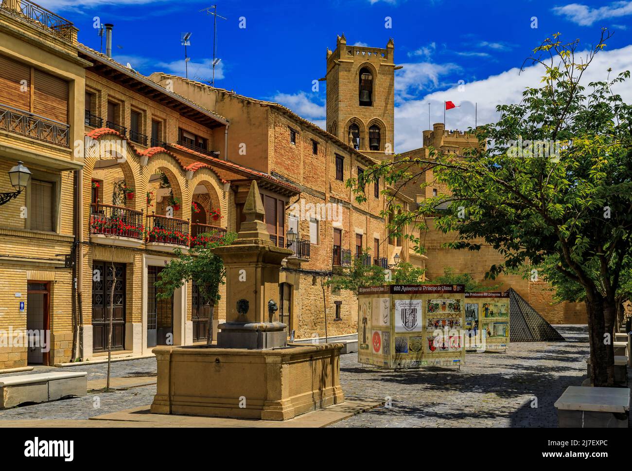 Olite, Spain - June 23, 2021: Medieval stone drinking fountain on Plaza Carlos III El Noble town square near the magnificent Royal Palace castle Stock Photo