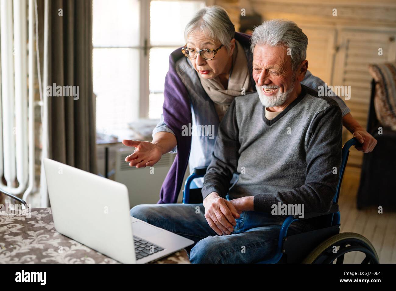Happy romantic senior couple hugging and enjoying retirement at home Stock Photo