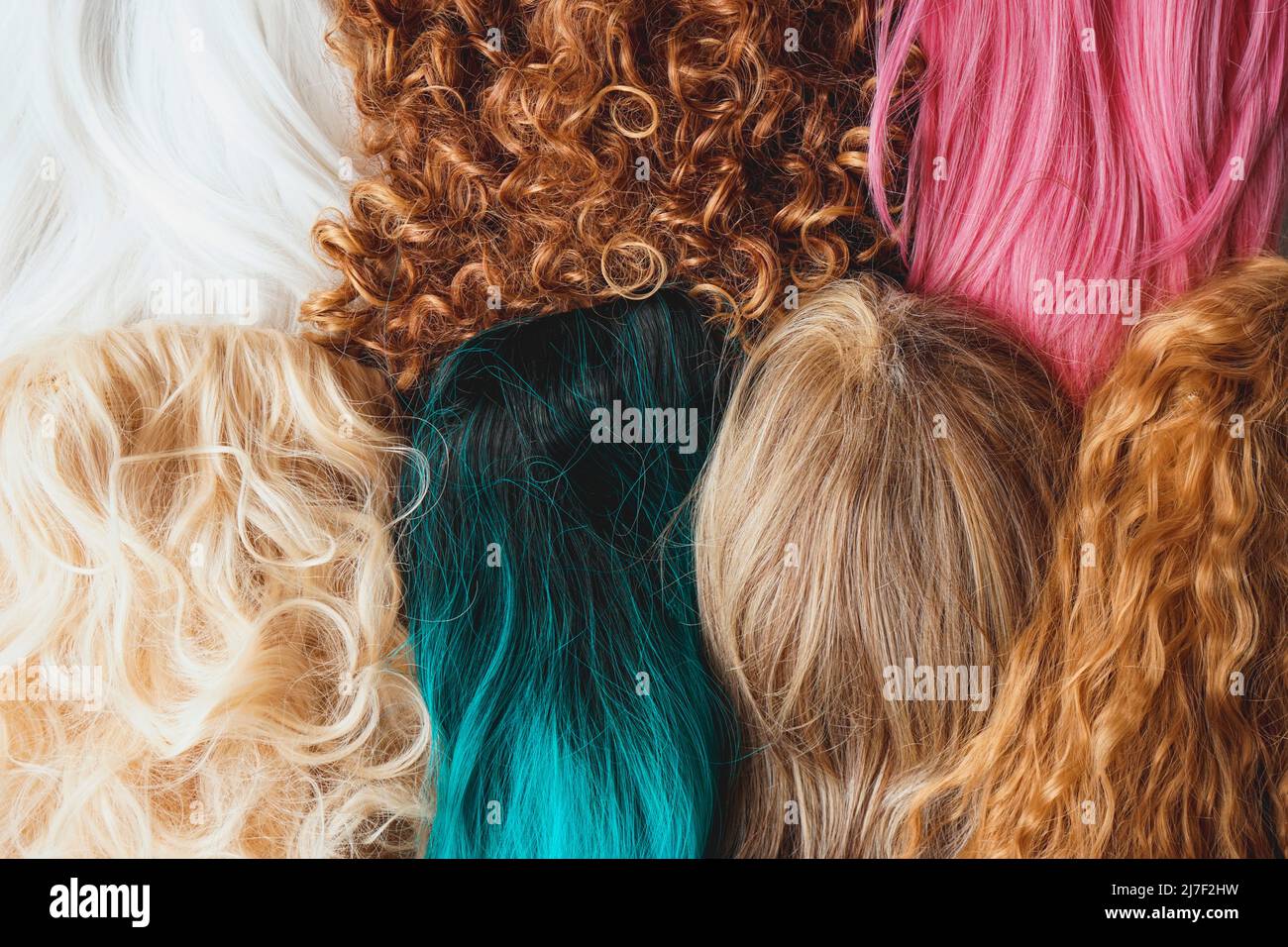 Image of assorted wigs of different styles and colors included dyed, curly and natural hair styles Stock Photo