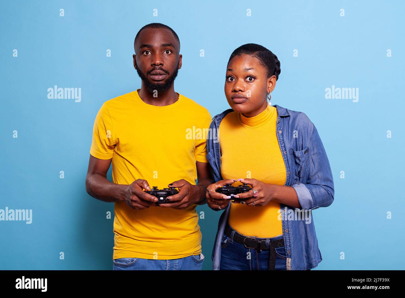 Cheerful boyfriend and girlfriend playing video games to win. Happy couple  using controller to play online game and winning gameplay on console.  People holding joystick to have fun Stock Photo - Alamy
