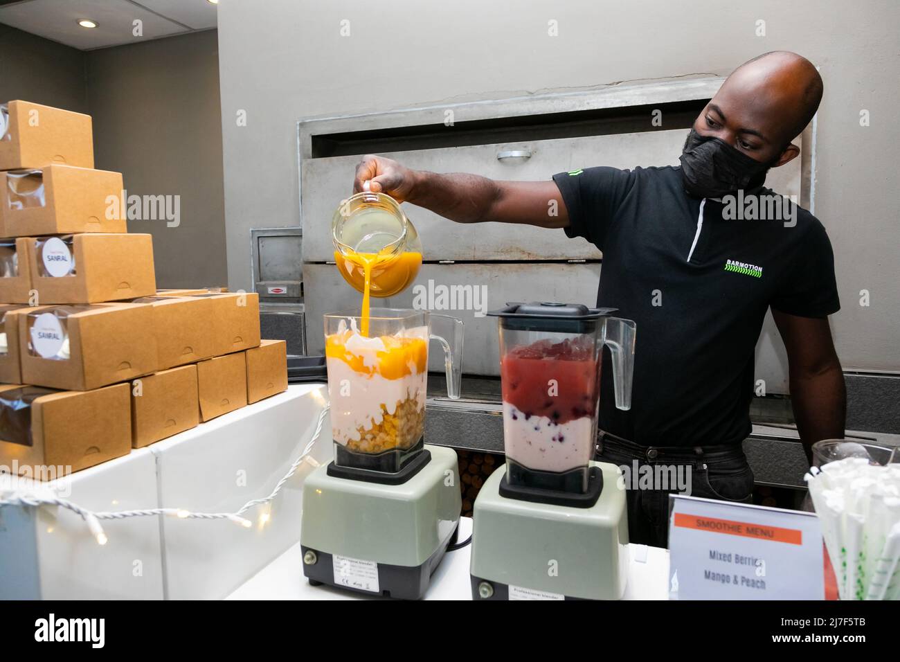 Cape Town, South Africa April 26, 2022 African male making fruit