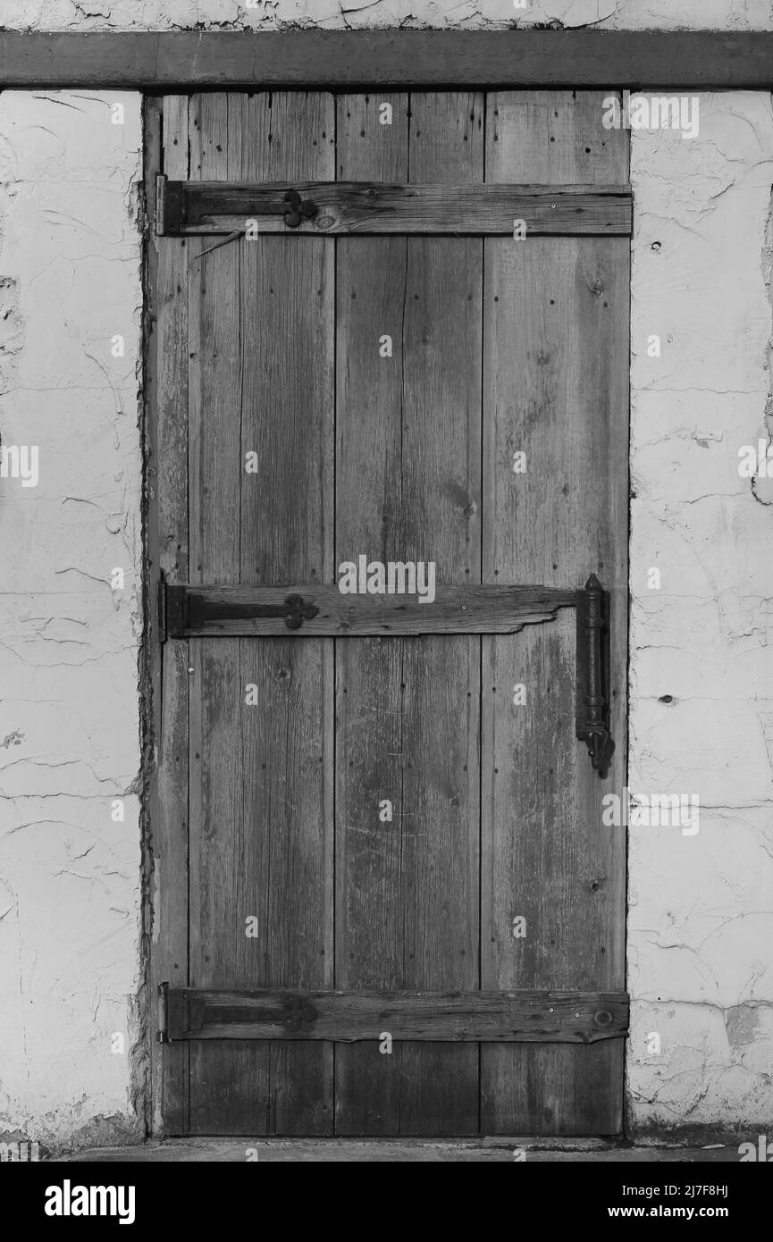 Vintage worn wooden door in black and white. Stock Photo