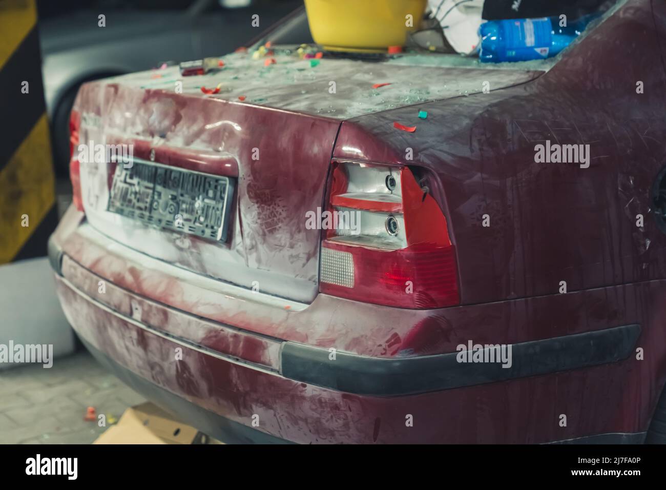 damaged car full of dust, filthy with broken screens used as a landfill