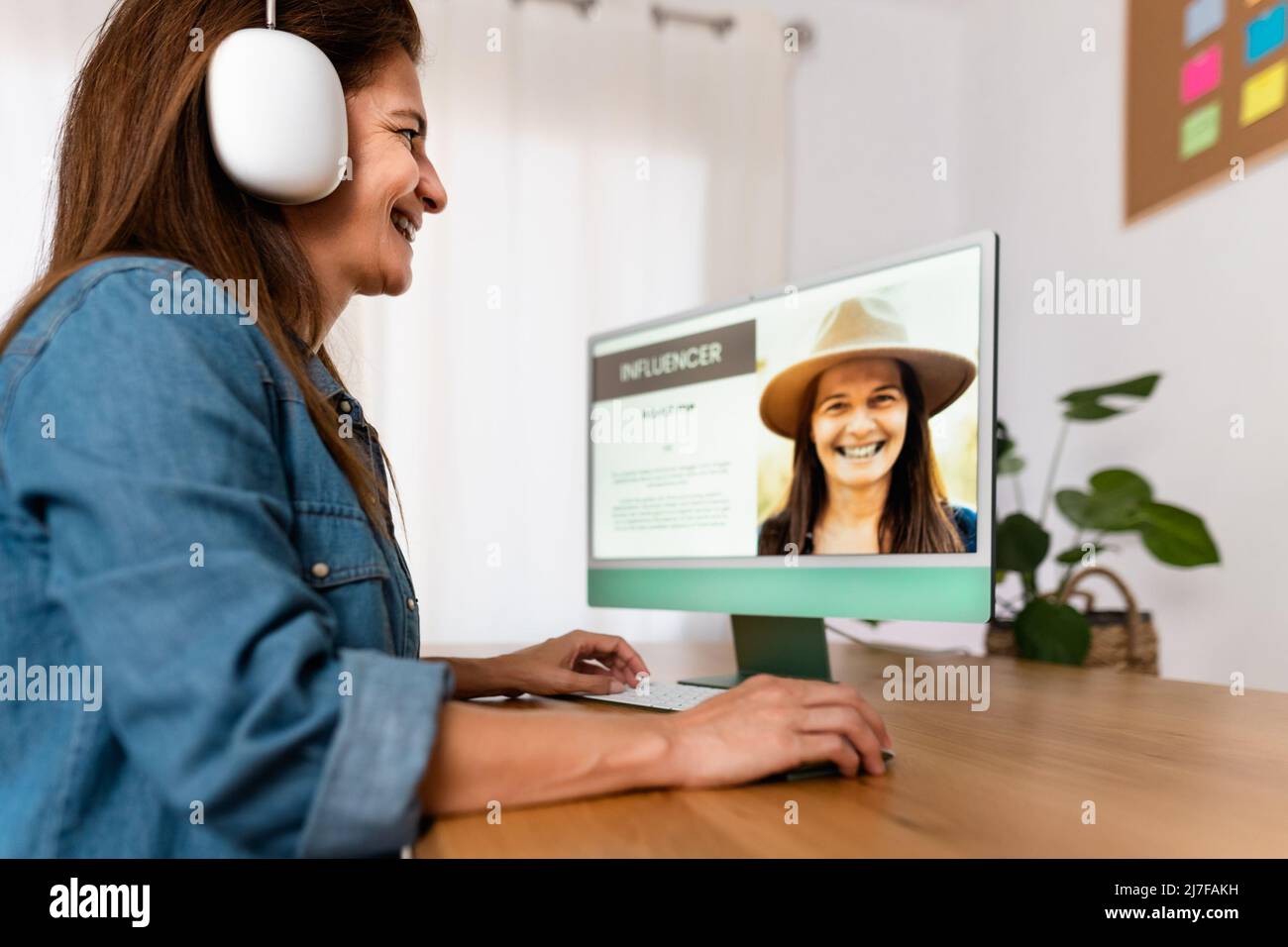 Happy Influencer woman working on computer from her home studio - Smart work and Technology concept Stock Photo