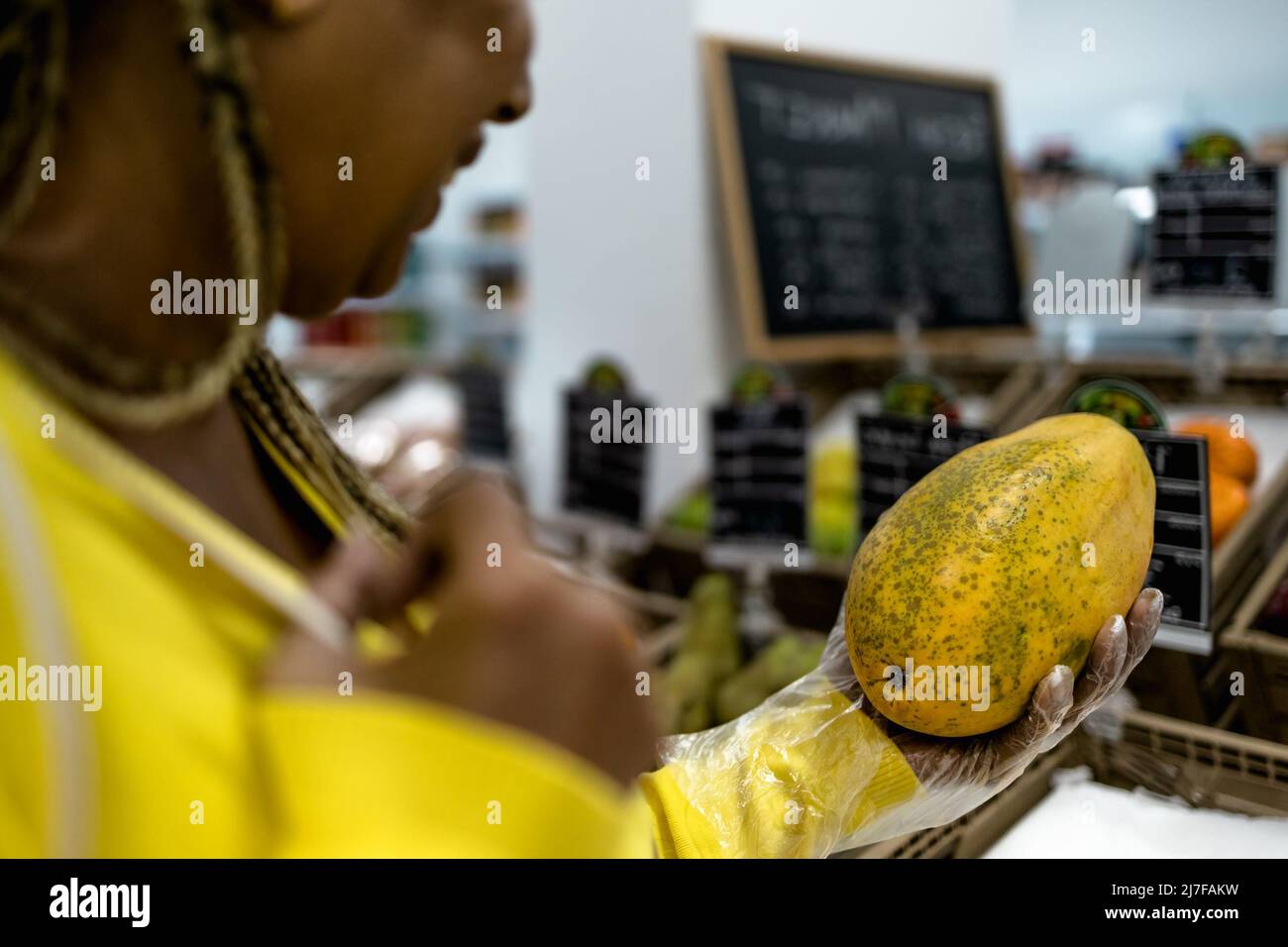 Senior African woman buying fresh fruits in supermarket Stock Photo