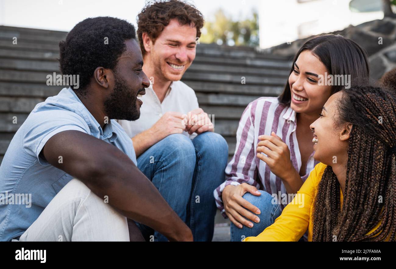 Young multiracial friends having fun hanging out together - Friendship and diversity concept Stock Photo