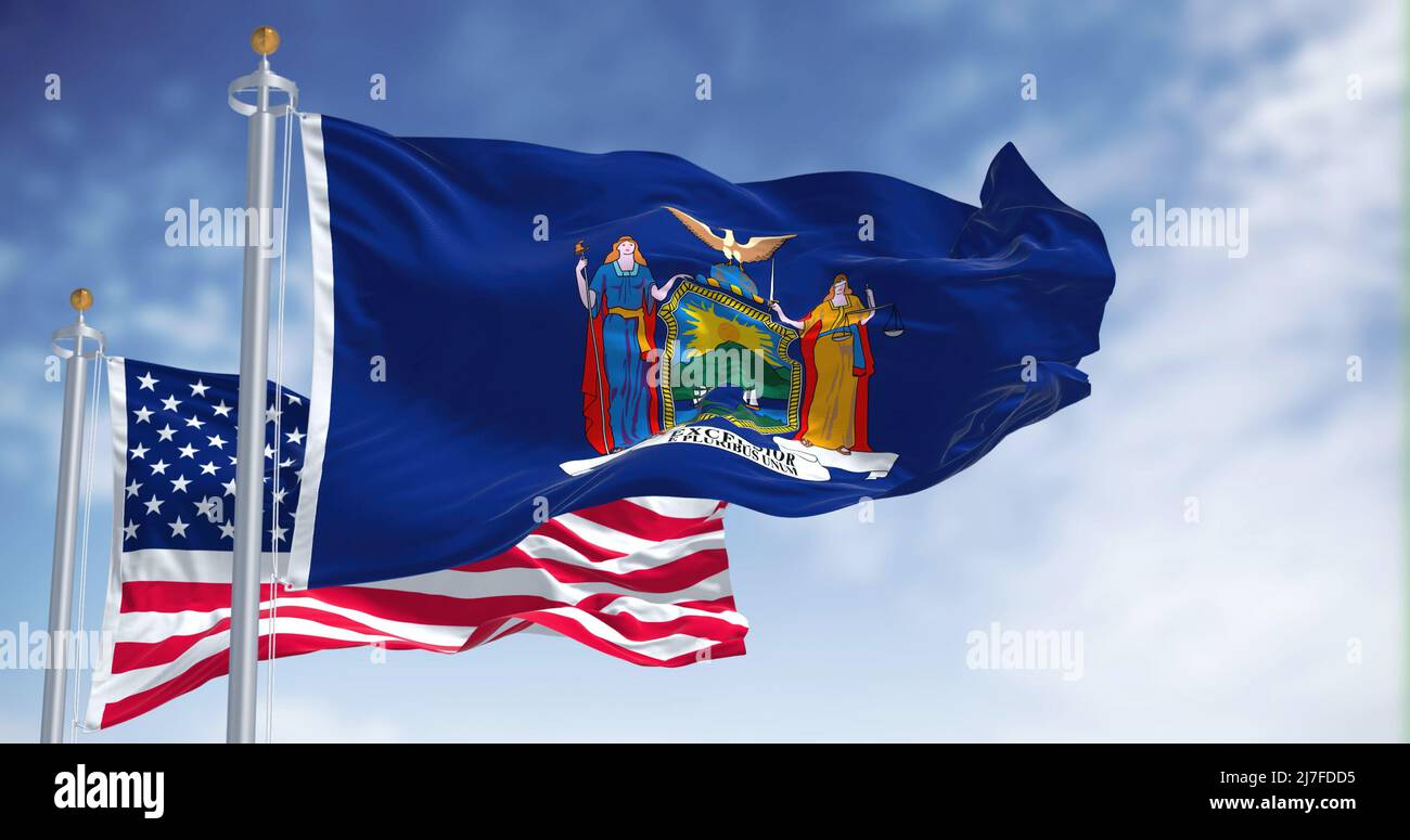 The New York state flag waving along with the national flag of the