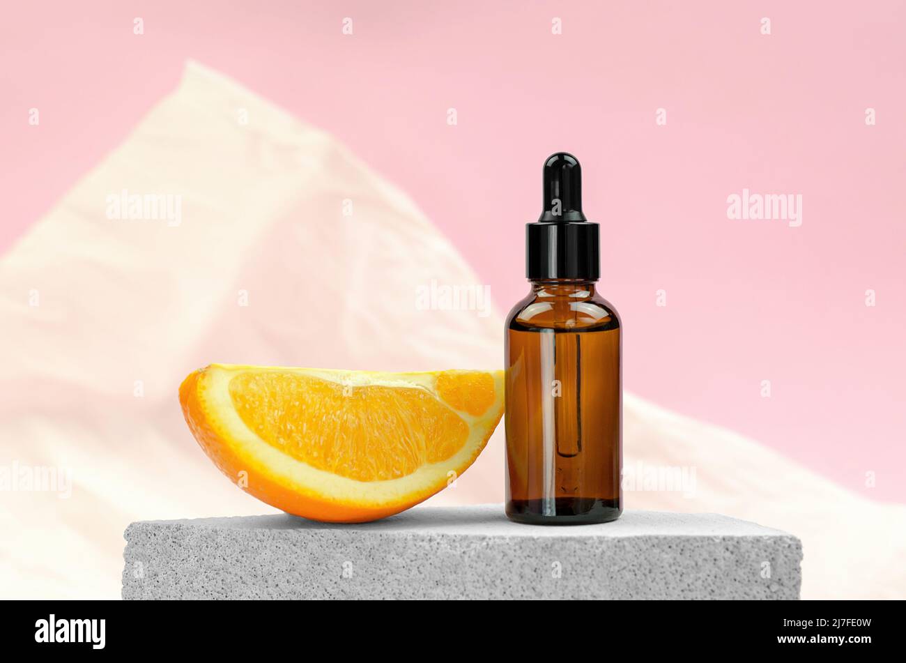 Orange oil in a bottle with a dropper and an orange slice. Natural oils