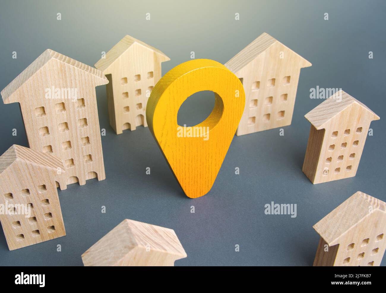 Yellow location indicator among houses. Delivery. Tracking and navigation. Internet of things, city management and city services municipal. Celebratio Stock Photo