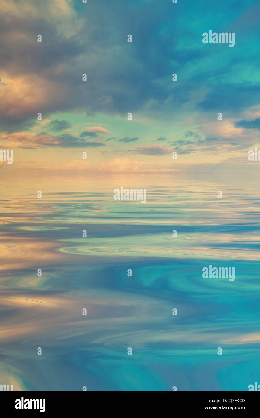 Pastel coloured clouds reflected on calm water Stock Photo