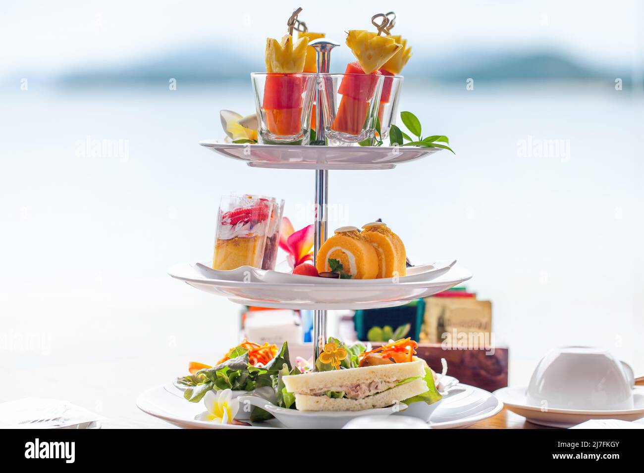 Traditional english high tea stand with selection of sweets, cakes, sandwiches Stock Photo