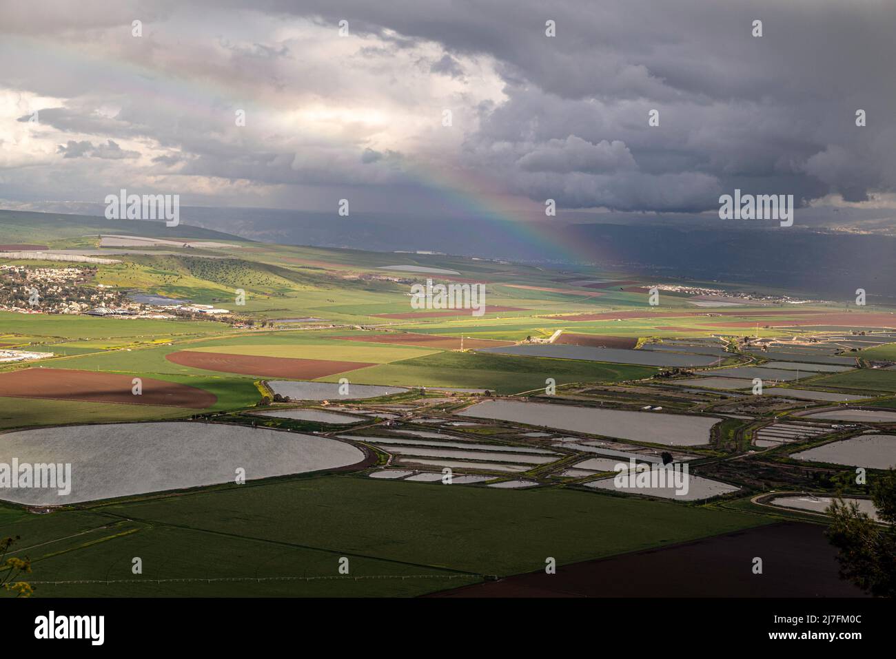 View of the Jezreel valley from Mount Gilboa observation point, Israel A rainbow can be seen in the background Stock Photo