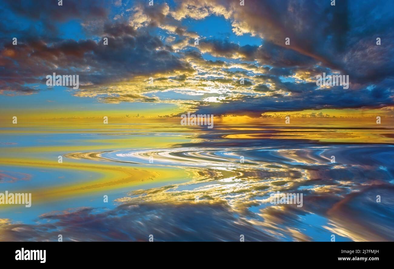Gathering storm clouds reflected on a smooth body of water Stock Photo
