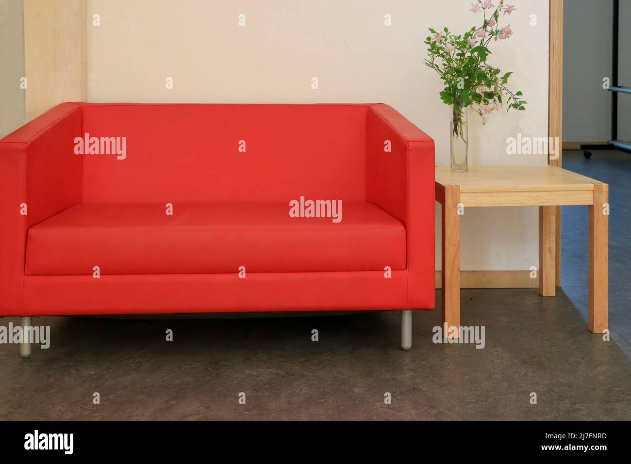 Red sofa and small wooden table Stock Photo