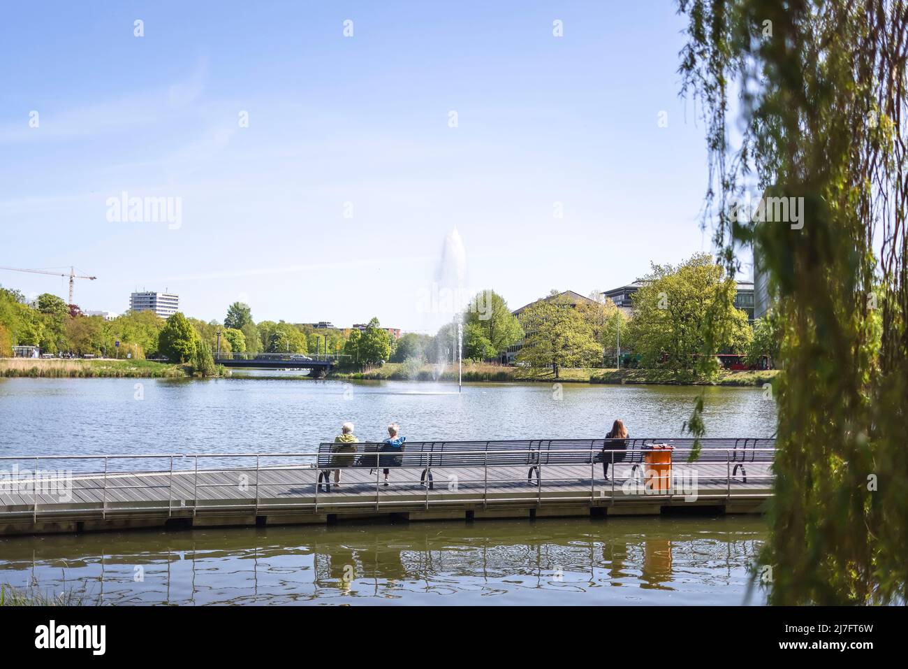 Kiel, Germany. 09th May, 2022. Passers-by sit on park benches at the Kleiner Kiel in the city center in sunny weather. Credit: Frank Molter/dpa/Alamy Live News Stock Photo