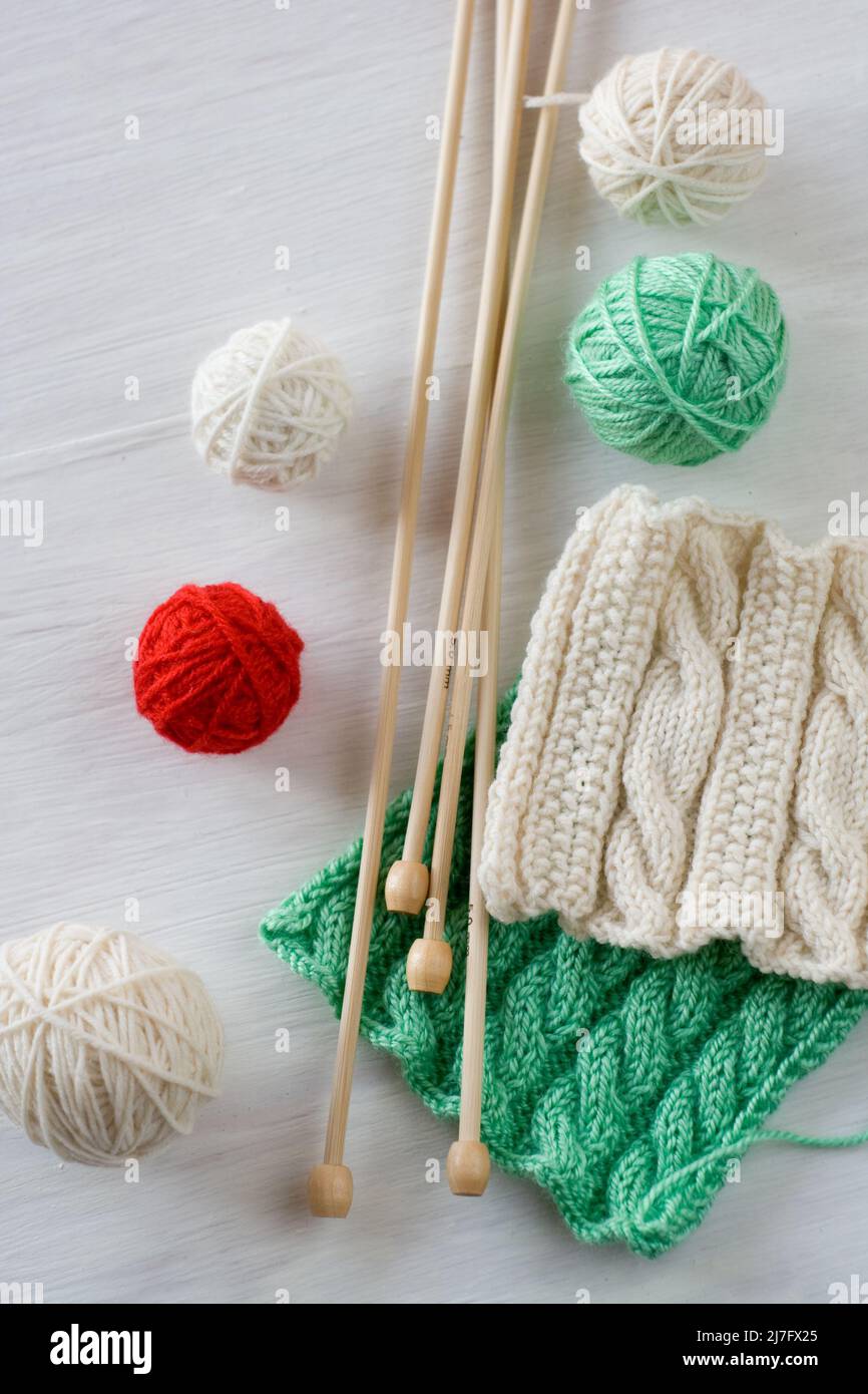 Two bright patterns, yarn balls and needles for knitting wooden white ...