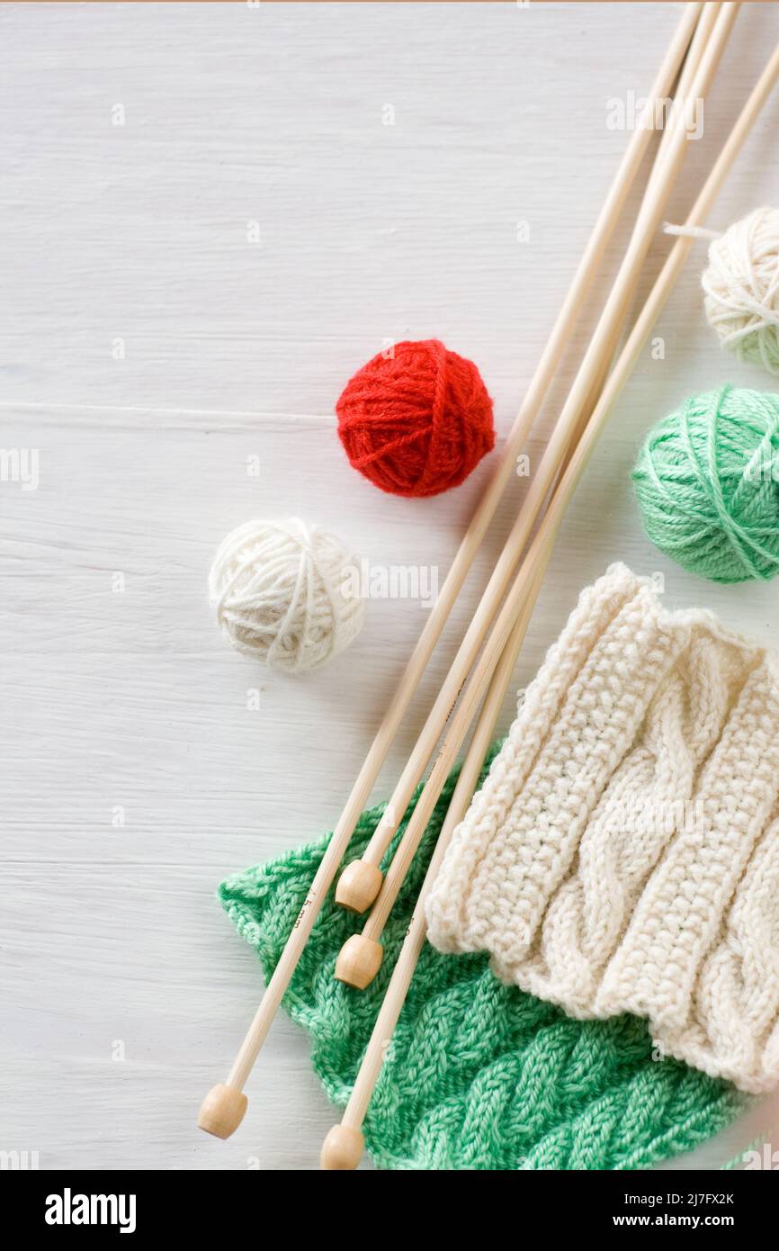 Two bright patterns, yarn balls and needles for knitting wooden white ...