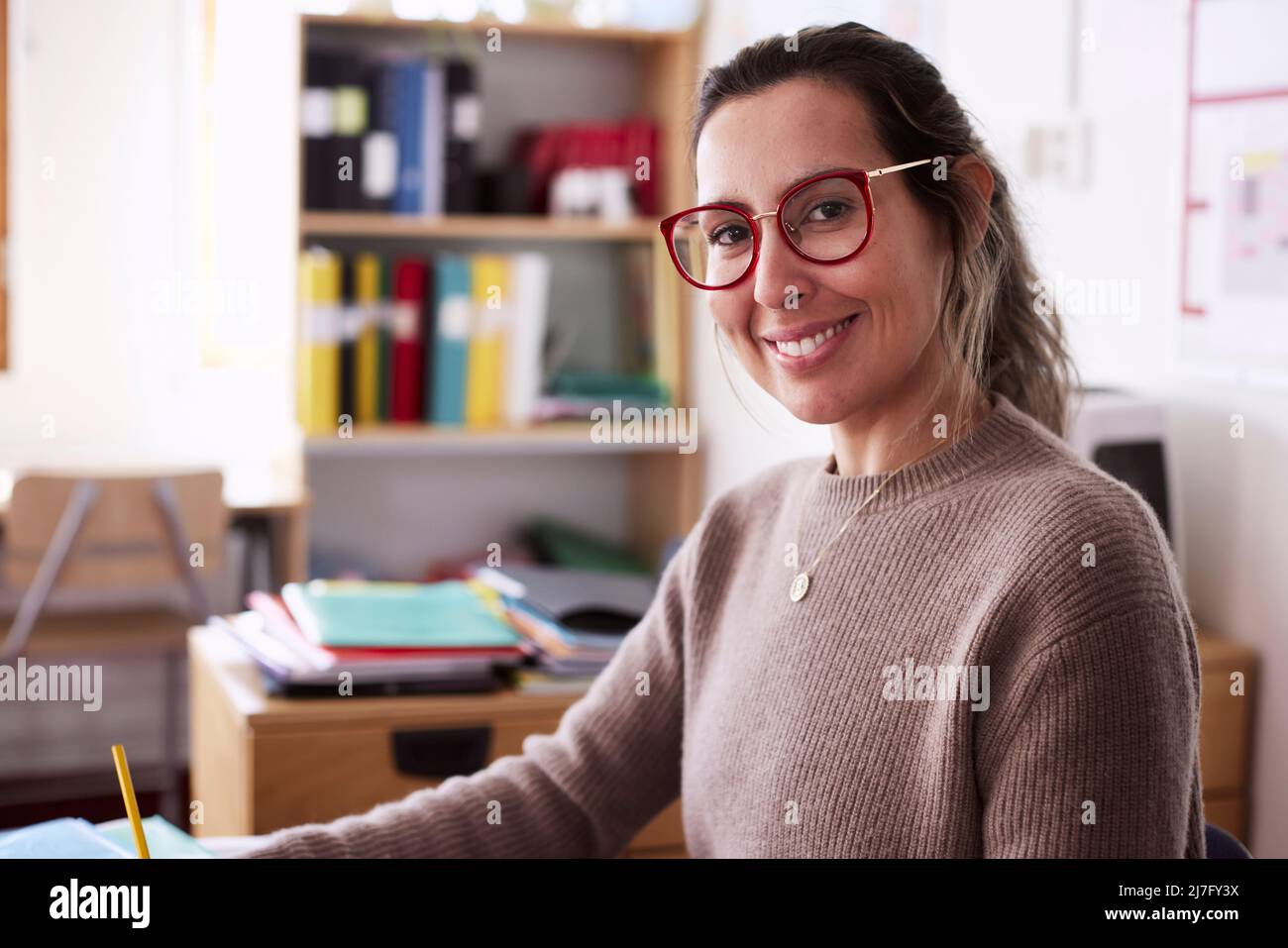 Female teacher in classroom working hi-res stock photography and images ...