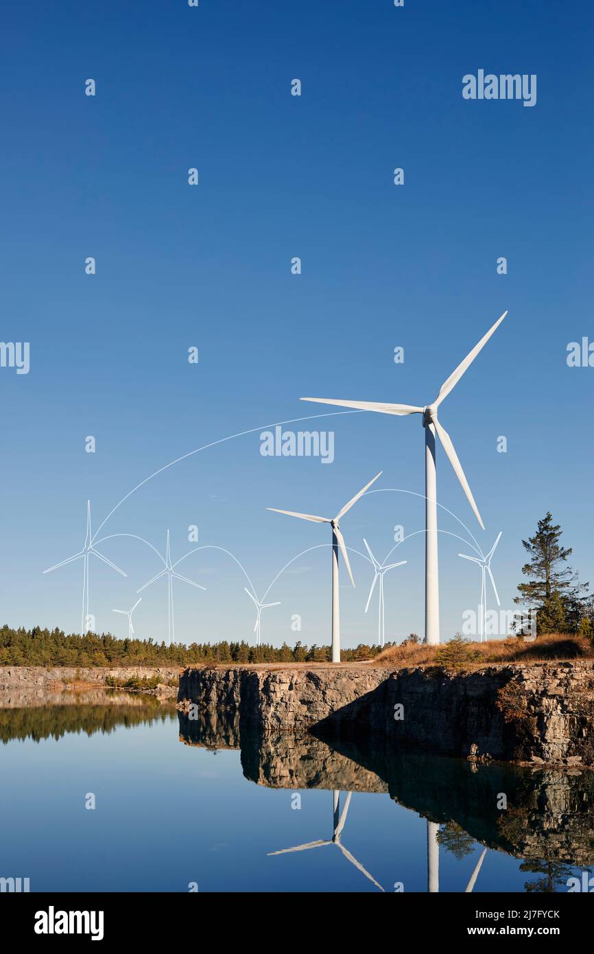 Wind turbines and blue sky reflecting in water Stock Photo - Alamy