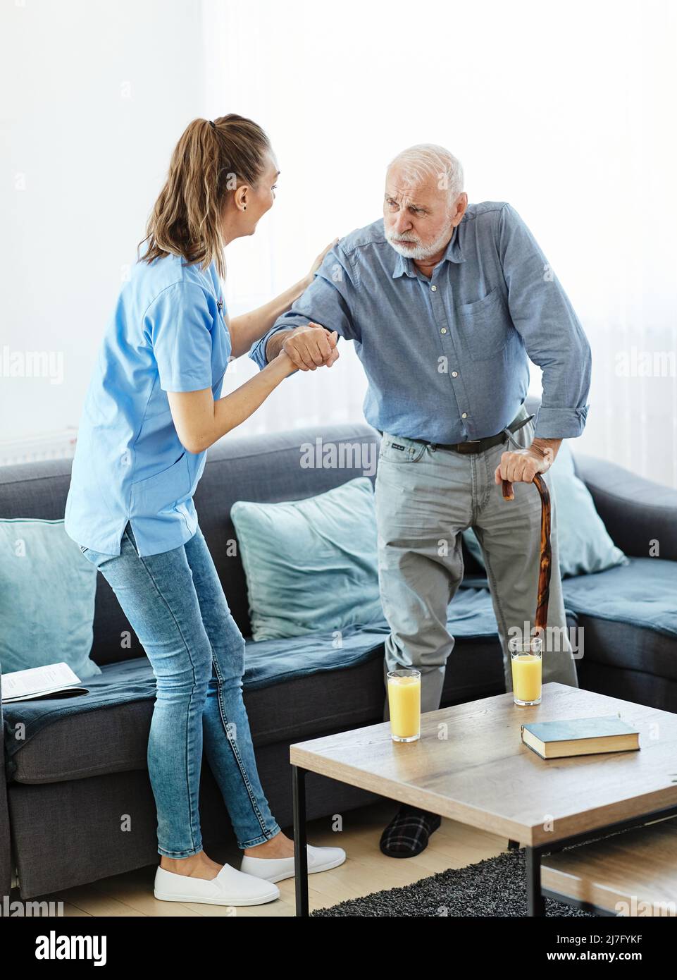 nurse doctor senior care caregiver help assistence walking cane stick retirement home nursing elderly man Stock Photo