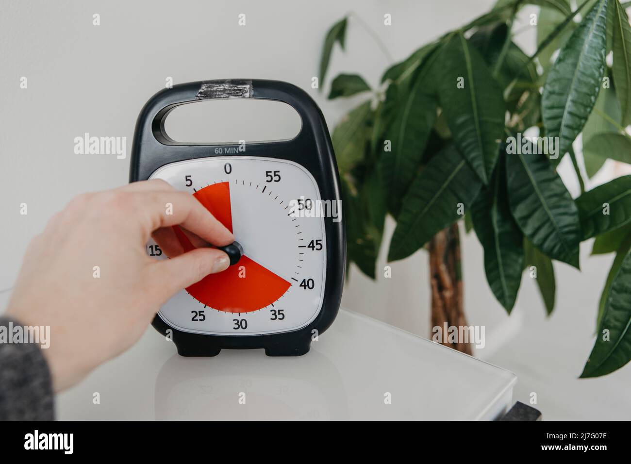 Hand setting alarm clock Stock Photo Alamy