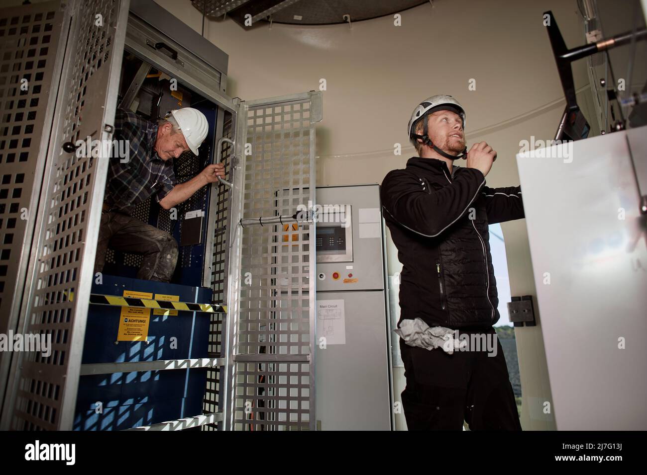 Engineers working in wind turbine Stock Photo