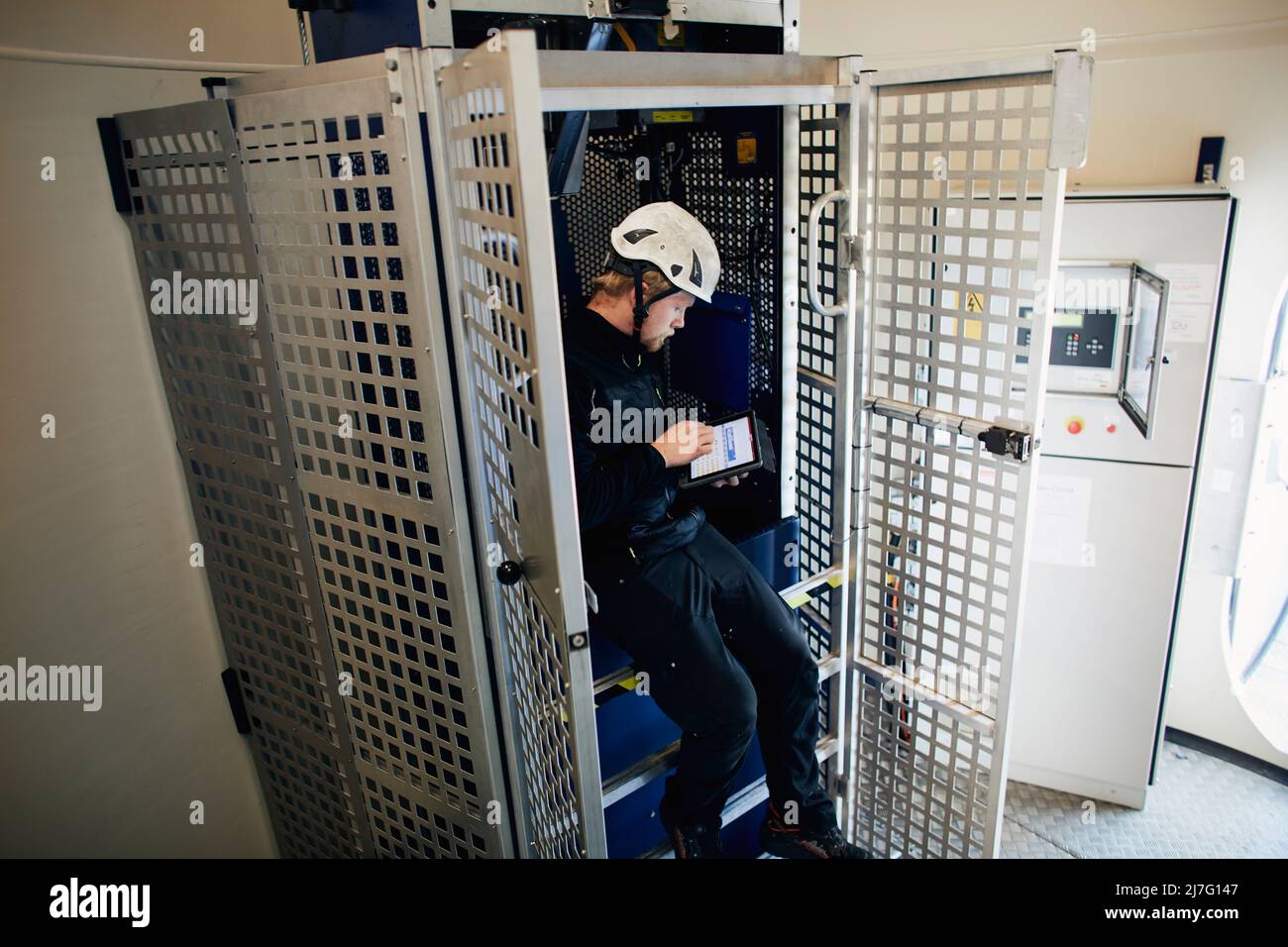 engineer-working-in-wind-turbine-stock-photo-alamy