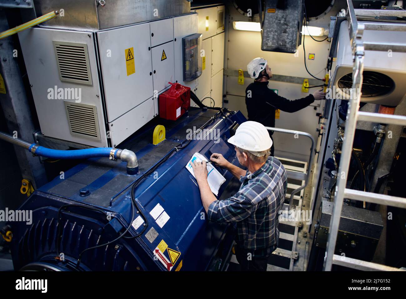 Engineers working in wind turbine Stock Photo Alamy