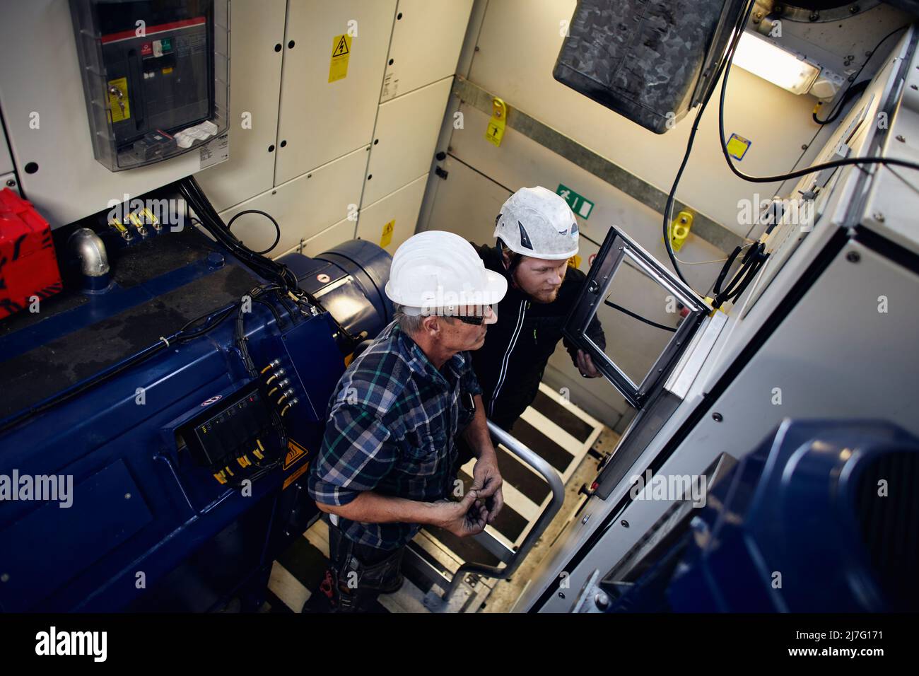 Engineers working in wind turbine Stock Photo Alamy