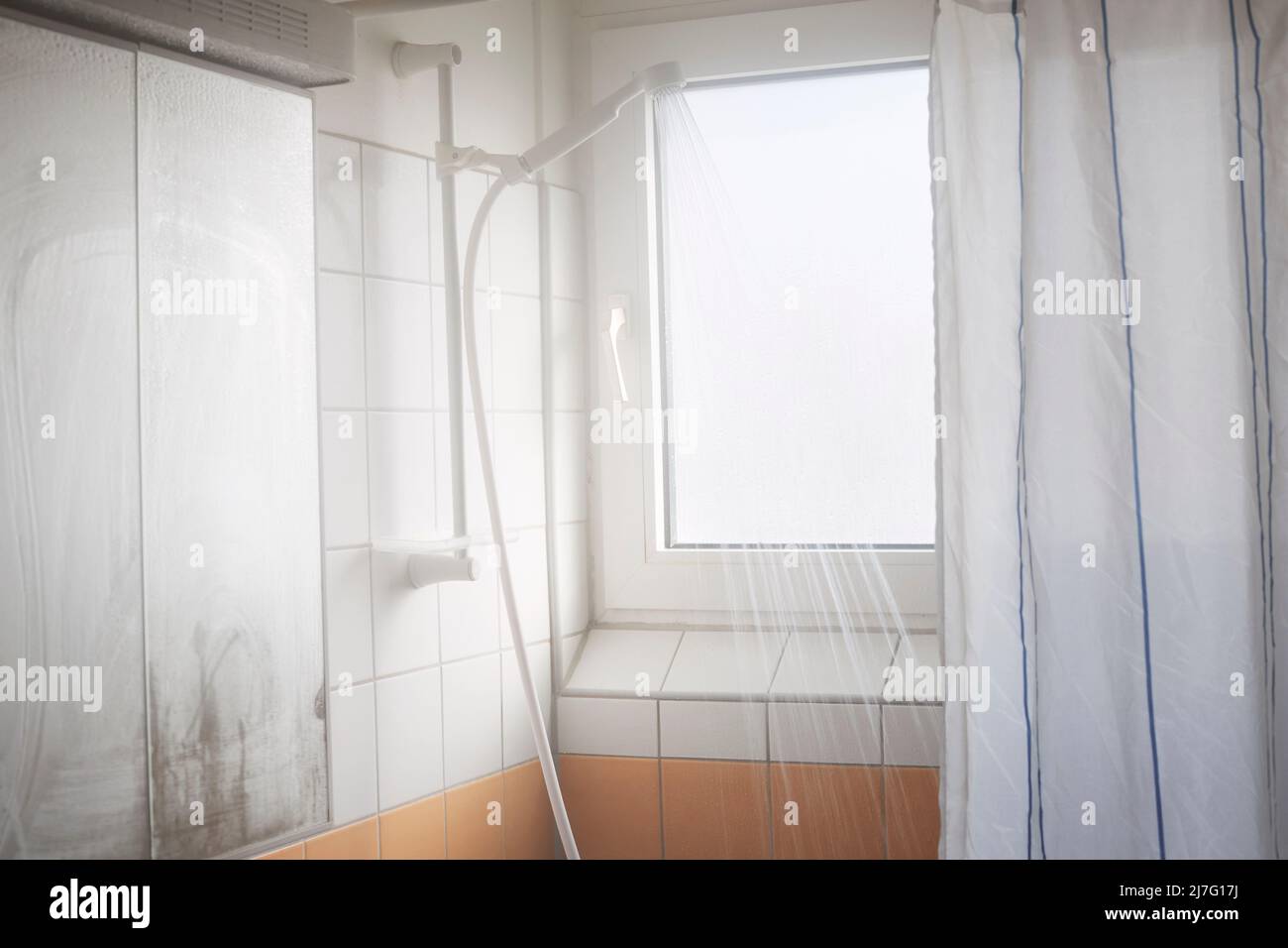 Water running from shower head in bathroom Stock Photo Alamy