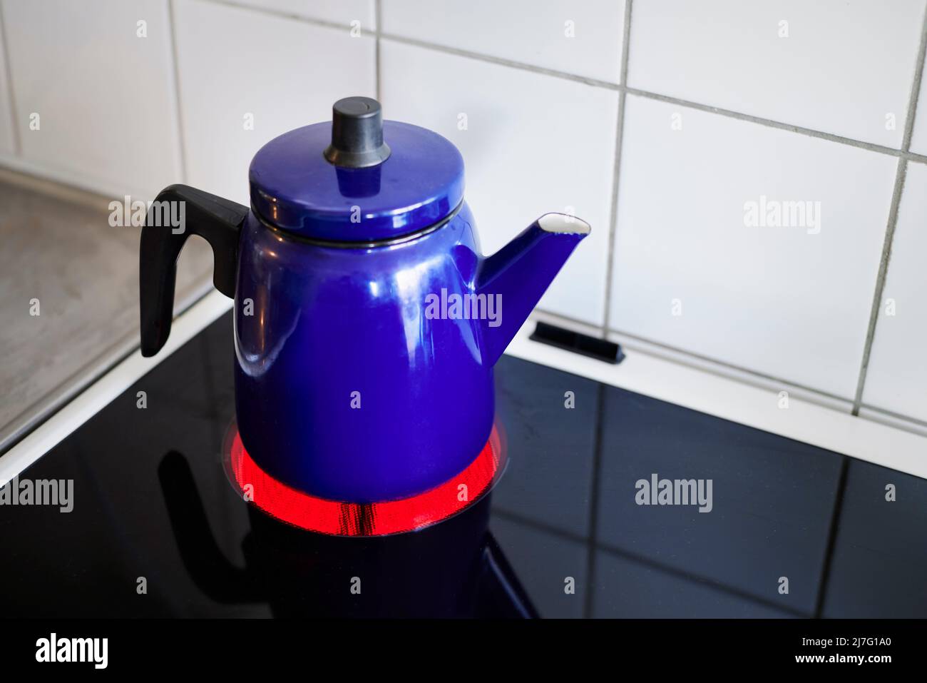Blue kettle on electric hob Stock Photo Alamy