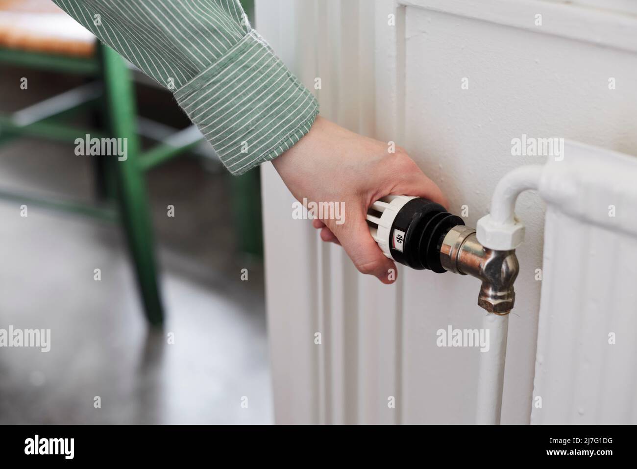 Hand adjusting temperature control in radiator Stock Photo Alamy